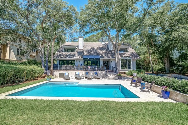 A two-story house with a swimming pool, outdoor seating, and a covered patio. - 6 High Rigger-2nd Row (20 yards) to the Ocean, Fully Renovated Home w/Pool. (Hilton Head Island)