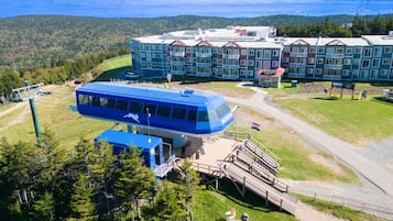 Experience the unique architecture of this scenic hotel, set amidst a forested landscape and overlooking a serene body of water.
