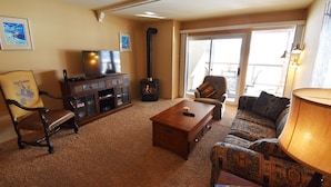 A cozy living room with a fireplace, a television, and comfortable seating. - On Lake! Deck, Views, Elevator, Hot Tub! Walk to Amphitheater, Marina, Dining (Dillon)
