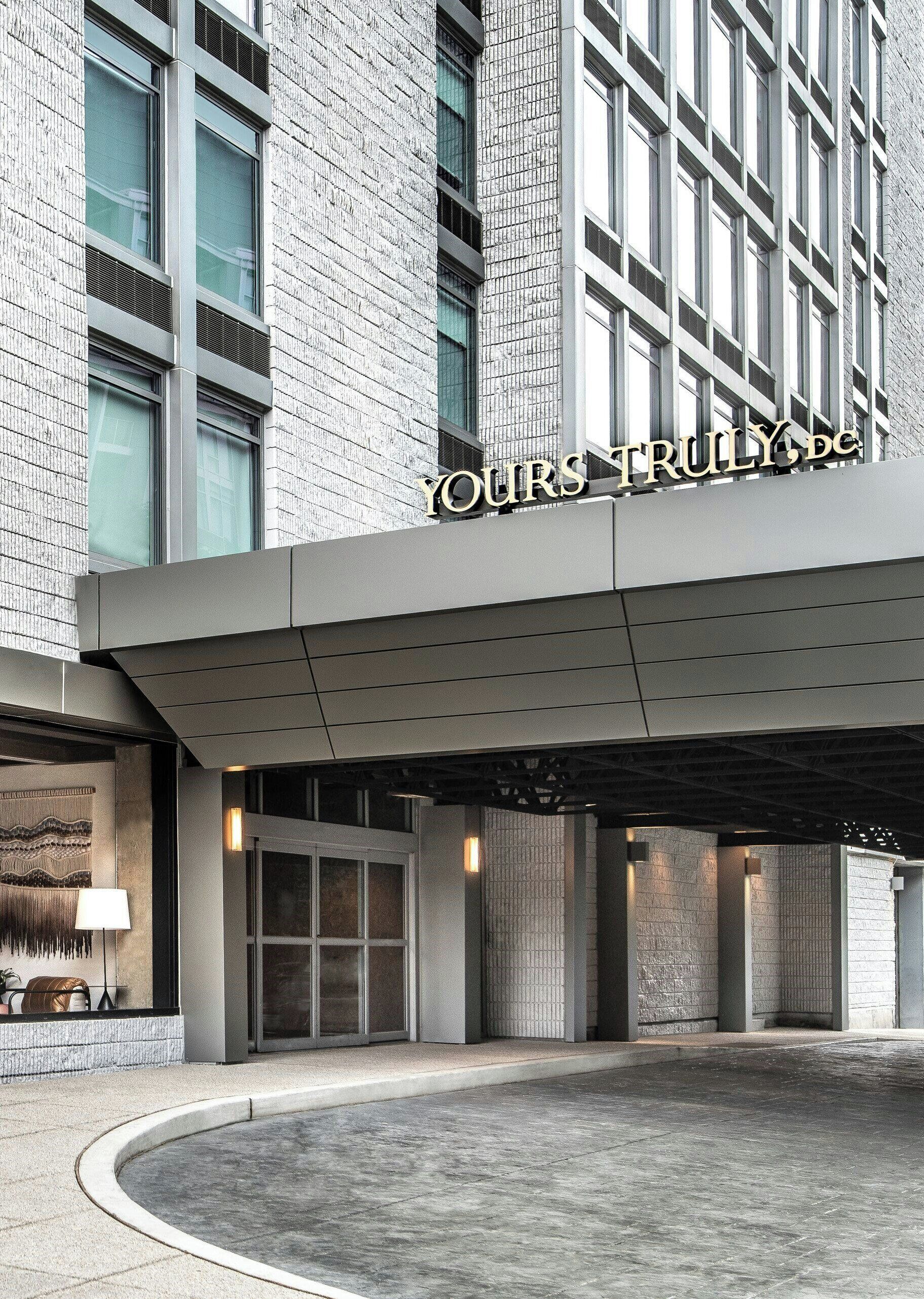 A modern building with a prominent sign reading 'YOUR TRULY, DE'.