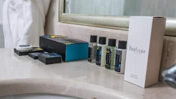 A bathroom counter with a box labeled 'Boutique' and several toiletry bottles.