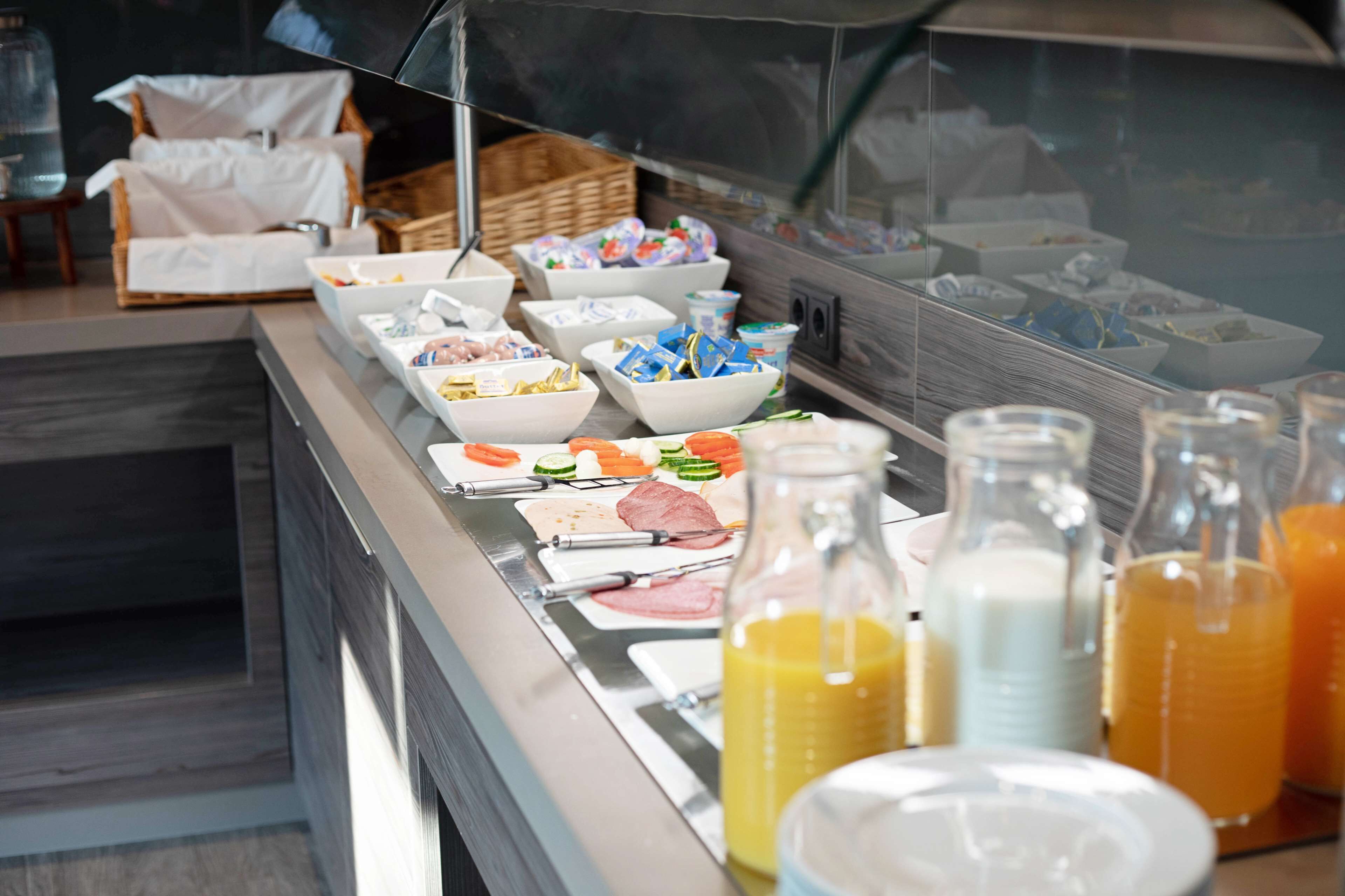 A buffet with various food items and beverages.