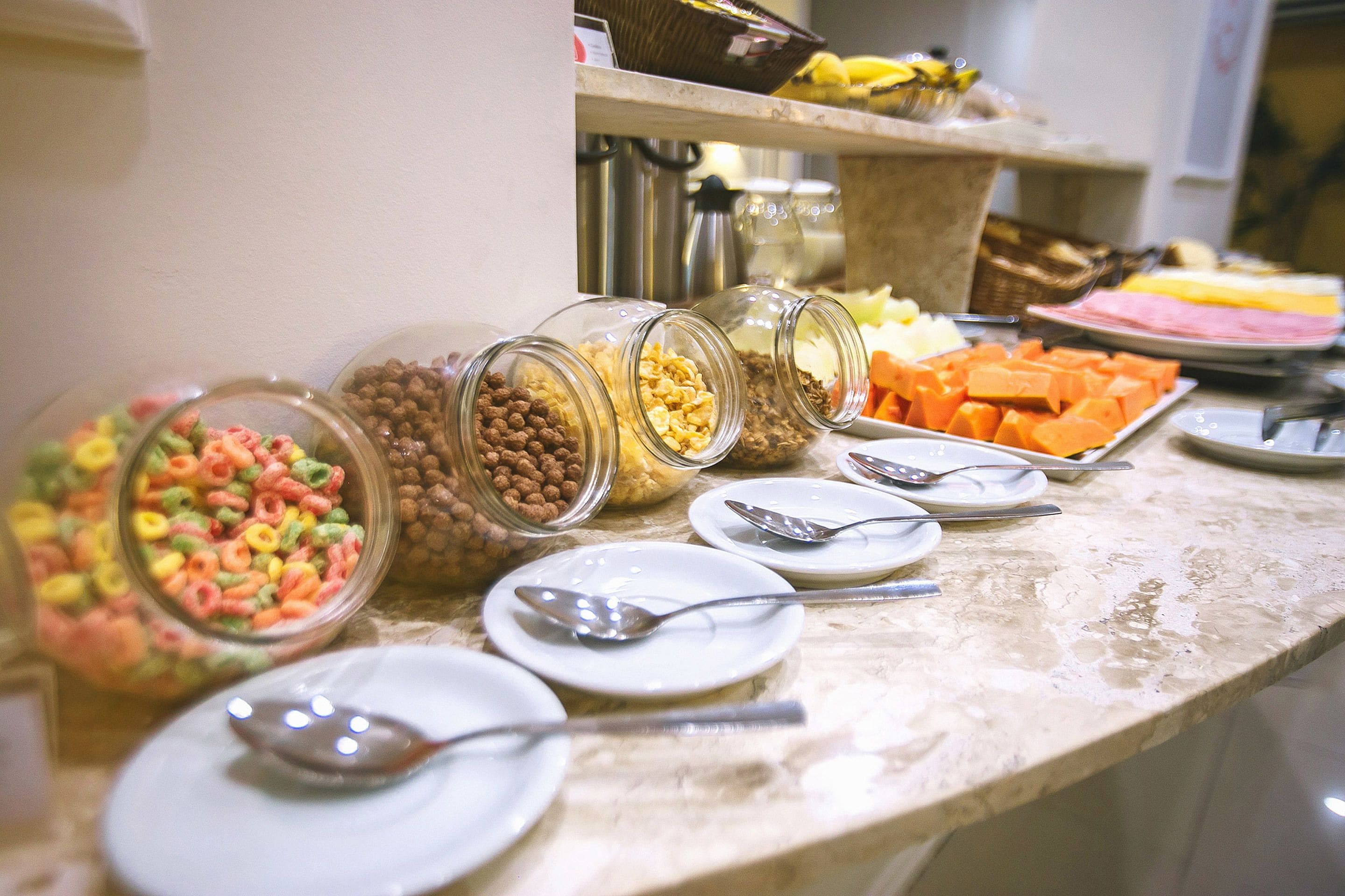 A buffet with various food items and utensils.