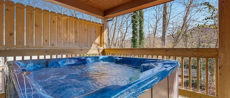 A wooden deck with a hot tub.