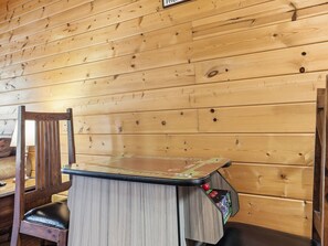 A wooden-paneled room with a small table and a chair.
