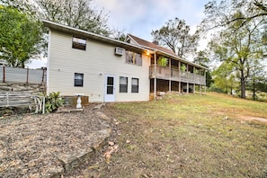 A two-story house with a front porch and a covered balcony. - Historic Bruno 'Hampton Creek Hideaway' on 2 Acres (Everton)