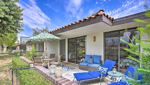 A patio with outdoor furniture, a glass door entrance, and a brick border. - Rancho Mirage Condo on Fairway w/ Resort Amenities (Rancho Mirage)