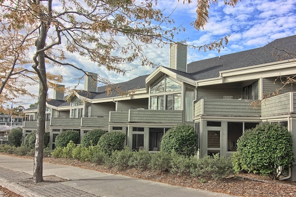 A row of townhouses with multiple balconies and large windows.