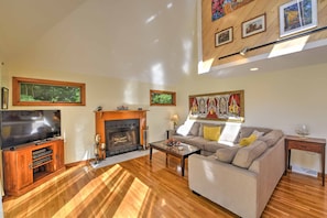 Cozy living room with a fireplace, flat-screen TV, and comfortable sofa.