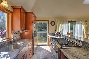 Enjoy cooking in this well-equipped kitchen with a central island, stovetop, and ample counter space.