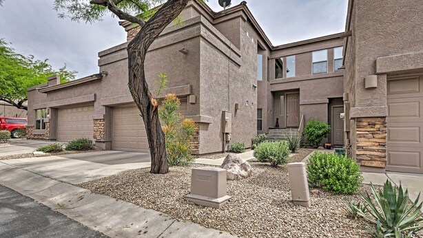 A modern two-story house with a stone facade, a garage, and a landscaped front yard with a tree and shrubs. - Golf Course View & Pool Access: Gold Canyon Gem (Gold Canyon)