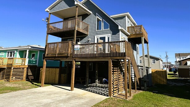 A two-story house with a balcony and a deck. - KD108- Near the Beach- 4 BRs, Just a Short Stroll to the Beach, Dog Friendly! (Kill Devil Hills)