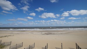 A beach with a wooden fence and a clear sky. - SN9241- Beautiful Oceanfront Home with Great Ocean Views and Dog Friendly! (Nags Head)