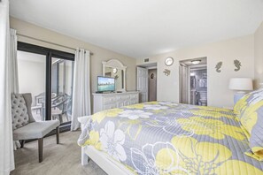 A hotel room with a bed, a television, a desk, and a chair. - *Fall into Savings-20% Off New Bookings thru 2026* (Garden City)