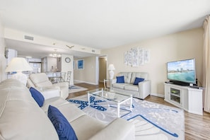 A modern living room with a sofa, coffee table, and TV. - *Fall into Savings-20% Off New Bookings thru 2026* (Garden City)