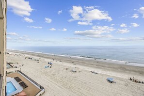 A beach view from a balcony with a pool and lounge chairs. - *Fall into Savings-20% Off New Bookings thru 2026* (Garden City)