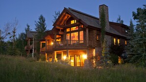 A log cabin with multiple balconies and large windows, surrounded by tall trees. - Salmonfly Lodge Remodeled Teton Springs Log Cabin in Victor w/ Hot Tub & A/C (Victor)