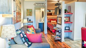A cozy living room with a sofa, a coffee table, and a bookshelf.