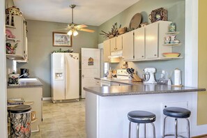 Enjoy cooking in this well-equipped kitchen with a central island and bar stools.