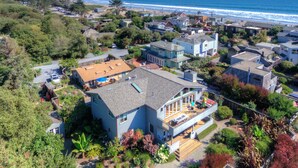 A coastal residential area with houses, a beach, and a hilly landscape. - Elegant Gated Beach Compound (Stinson Beach)