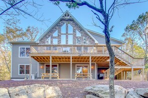 A two-story log cabin with a balcony, stone exterior, and a stone fireplace. - Summit by PMR, 8BR Guest Favorite, Elevator, Handicap Accessible, Sleeps 26 (Lake Harmony)