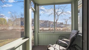 A porch with a view of houses and a road. - 107 Pointes North Inn | Downtown Charlevoix Gem | Indoor/Outdoor Pool (Charlevoix)