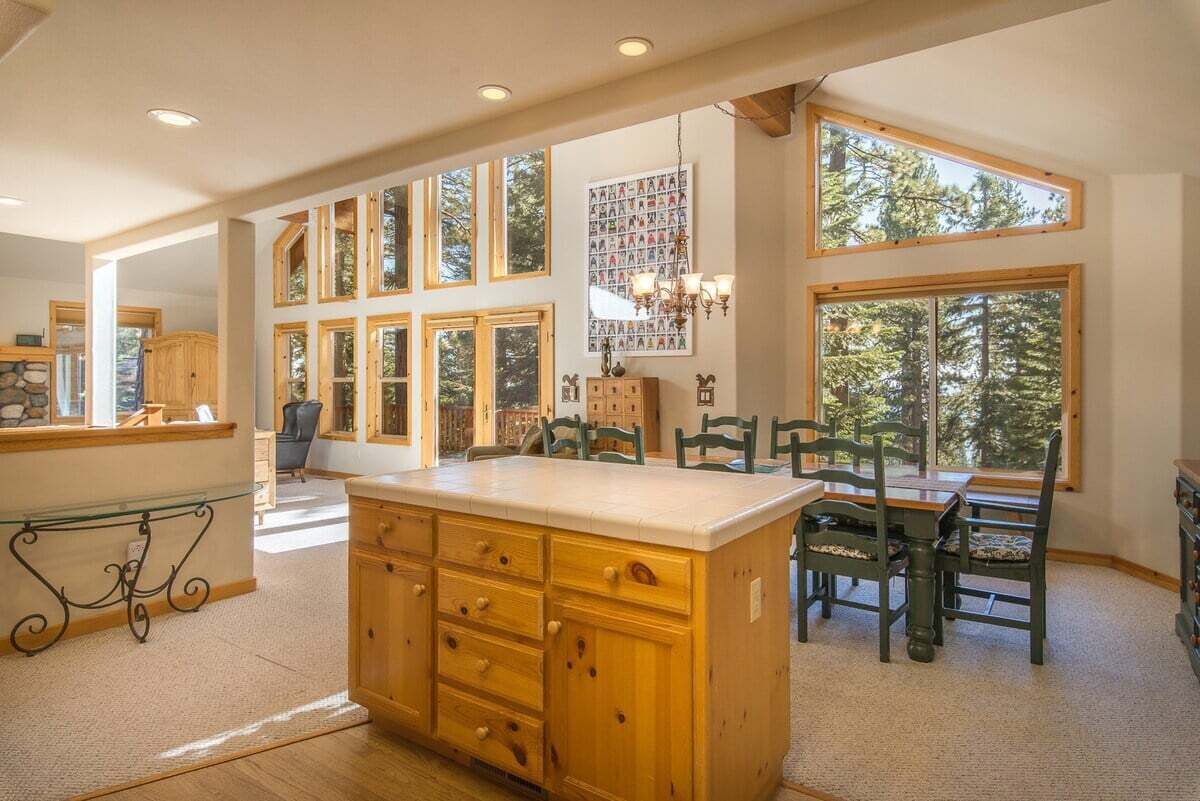 Dining, kitchen, and living room with peak views of the Lake
