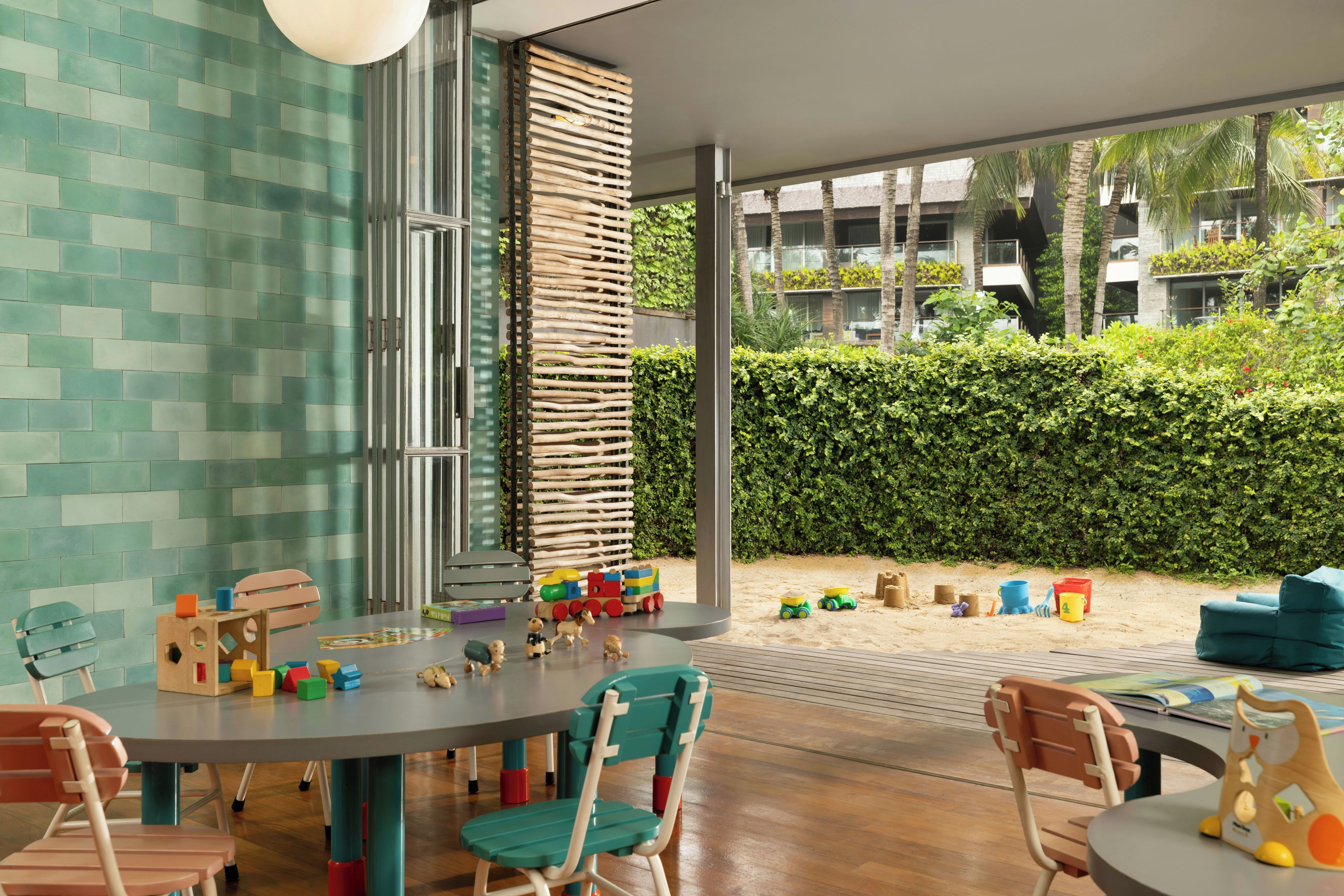 A children's play area with a round table, chairs, and toys.