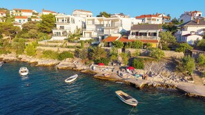 Une ville côtière avec des bâtiments, une côte rocheuse et des bateaux.