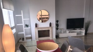 A modern living room with a glass dining table, red runner, and contemporary furniture. - Casa de Mairena - Sea/Mountain Views + Infinity Pool (Marbella)