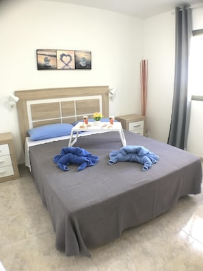 Relax in comfort with a large bed, bedside tables, and a convenient tray for essentials.