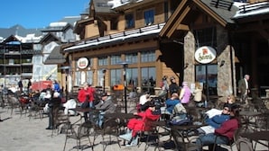 A ski resort with outdoor seating and a restaurant named "Skiers".