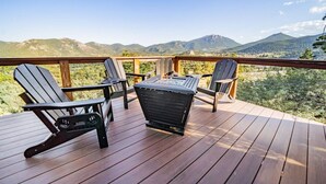 A wooden deck with Adirondack chairs and a table, overlooking a mountainous landscape. - Best Views, Hot Tub Near National Park! King Beds! (Estes Park)