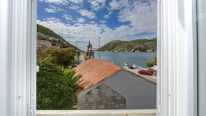 A coastal town with a prominent church, a bridge, and a body of water.