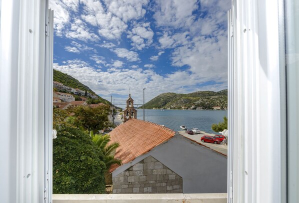 A coastal town with a prominent church, a bridge, and a body of water.