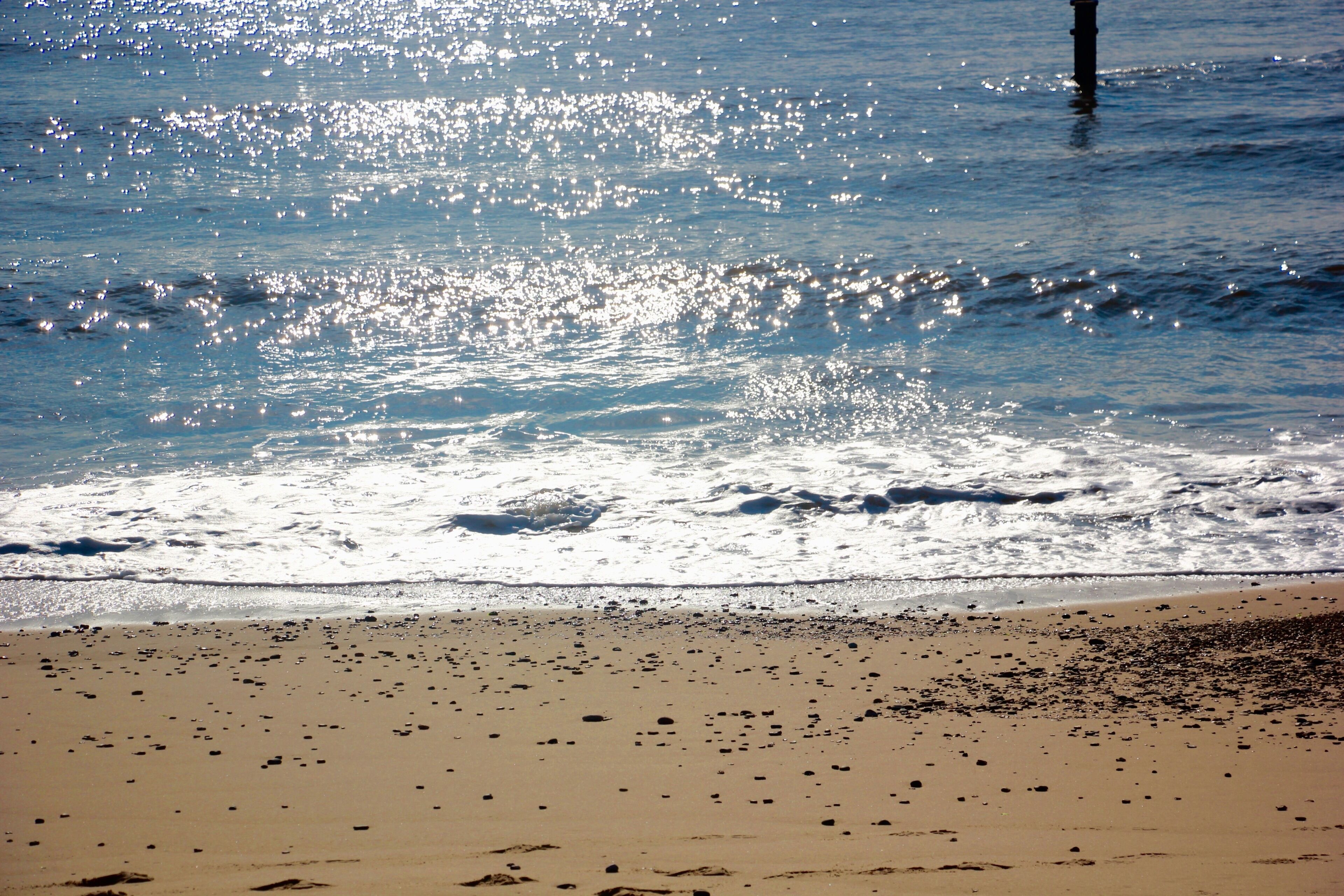 A beach with sand and water.
