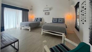 A bedroom with two beds, a ceiling fan, an air conditioner, and a bedside table. - Private Ocean-View Family Villa with Pool in Islita, Costa Rica (Islita)