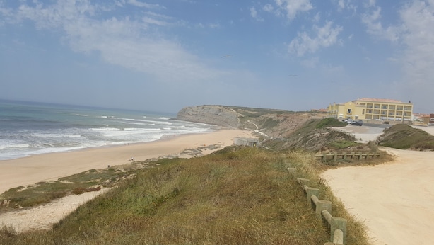 A coastal hotel with a sandy beach, rocky cliffs, and a clear sky. - Villa on Beach Azul Beach (Silveira)