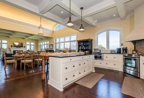 Enjoy cooking in this well-equipped kitchen with a large island, sink, and stainless steel appliances.