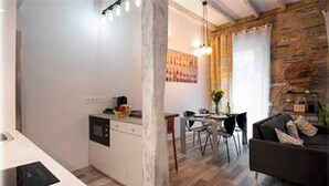 A modern kitchen with a dining area and a living space. - BartoloBeachApartment. 100m from La KONTXA Beach (Donostia)