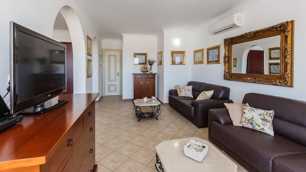 A living room with a flat-screen TV, a sofa, a coffee table, and a cabinet. -  Idyllic Villa near Split, pool, garden, free parking and stunning view, (OWNER) (Solin)