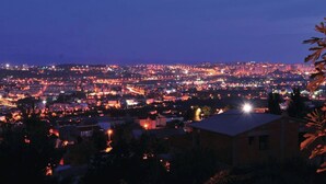 A nighttime cityscape with illuminated buildings and streets. -  Idyllic Villa near Split, pool, garden, free parking and stunning view, (OWNER) (Solin)
