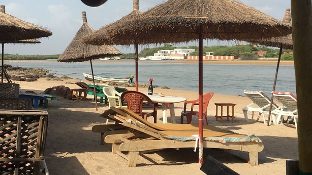 A beach with thatched umbrellas, lounge chairs, and a view of boats on the water. - Charming recent air-conditioned 3 bedroom villa with swimming pool  (Ngaparou)