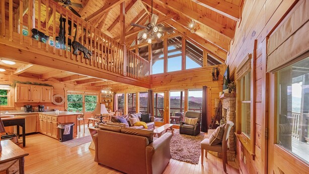 A spacious wooden cabin with a loft bedroom, a cozy living area with a sofa and fireplace, and a kitchen with wooden cabinets. - EndlessViewSleeps15.Amazing Viewover  Dollywood&ParrotMtn.Close to Pkwy,private (Sevierville)