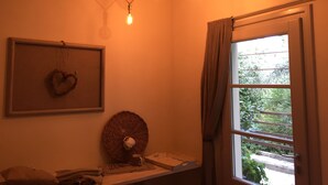 A room with a window, a wall-mounted light fixture, a heart-shaped decoration, and a wicker basket with a cup. - DOUBLE ROOM  (Molina di Quosa-rigoli)