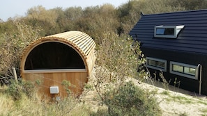 Sauna with unobstructed panoramic view over the dunes in the nature reserve.