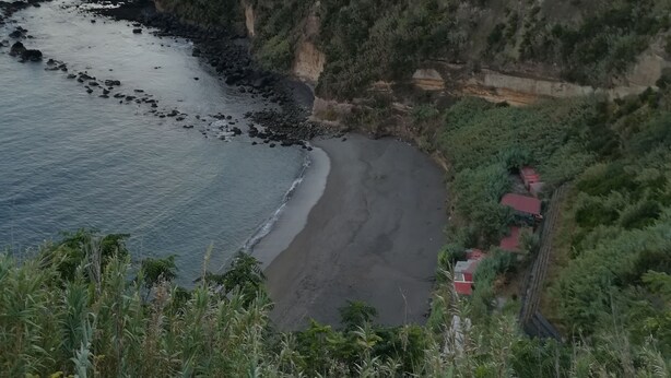 A coastal landscape with a beach, cliffs, and vegetation. - Casa Formosa das Furnas (Povoação)