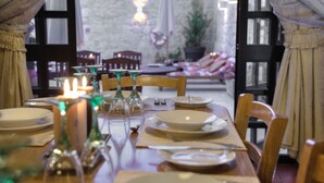 A dining table set with plates, glasses, and cutlery, with chairs around it. - Id-Dwejra  House  of Character with Privite Pool,  swim Jet and Jaccuzzi (Zejtun)