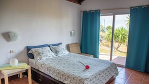 A bedroom with a bed, a bedside table, a lamp, and a view of the outdoors. - La Hoya, cozy, quiet country house   (alajero)