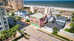 A coastal residential area with multi-story buildings, a beach, and a road. - 3 Bedroom 3 Bath Ocean Views Rooftop Deck Sleeps 8 (Jacksonville Beach)